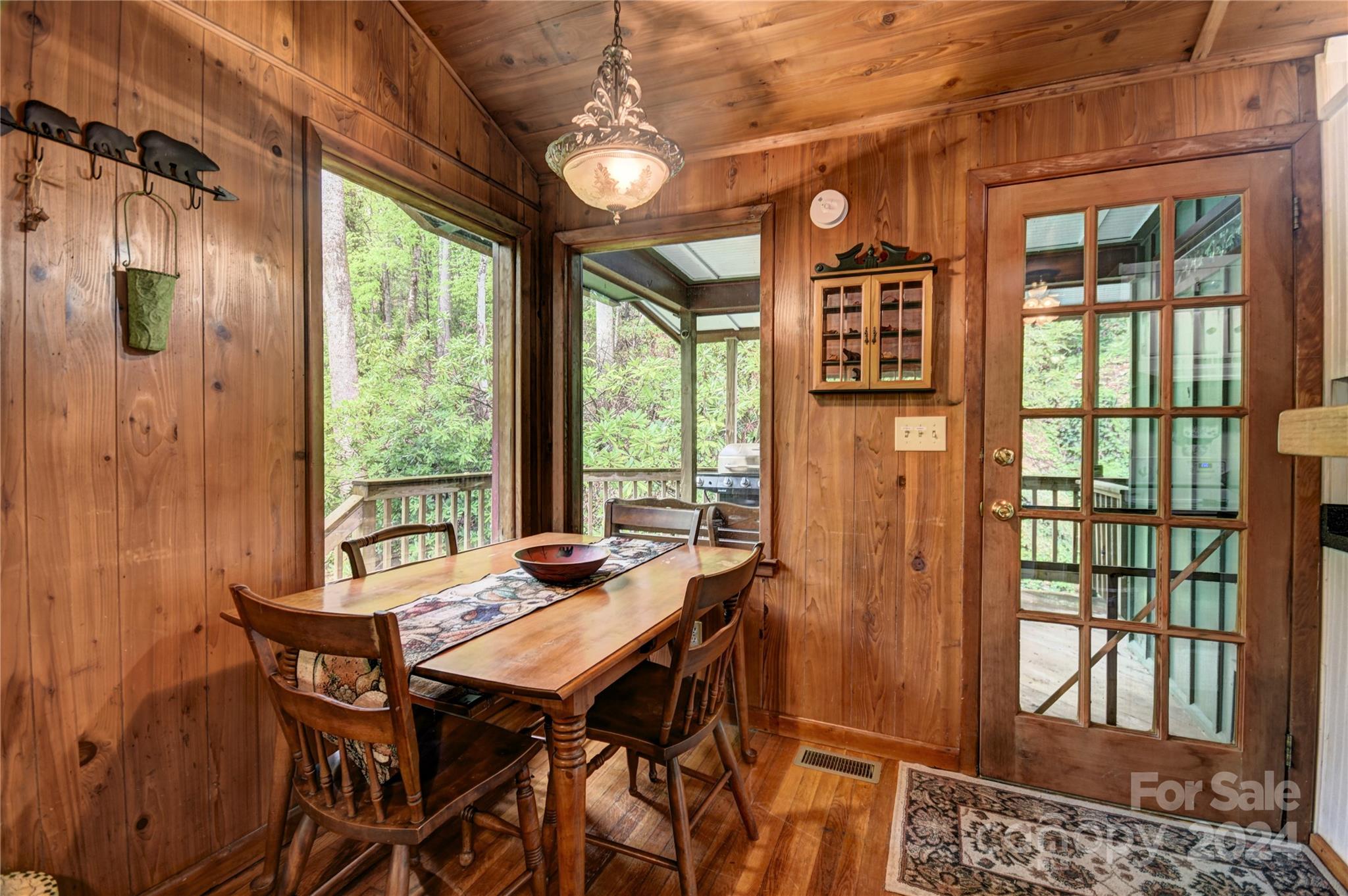 367 Johnson Branch Road Maggie Valley, NC 28751 - Photo 6 of 28 a view of a dining room with furniture large windows and wooden floor