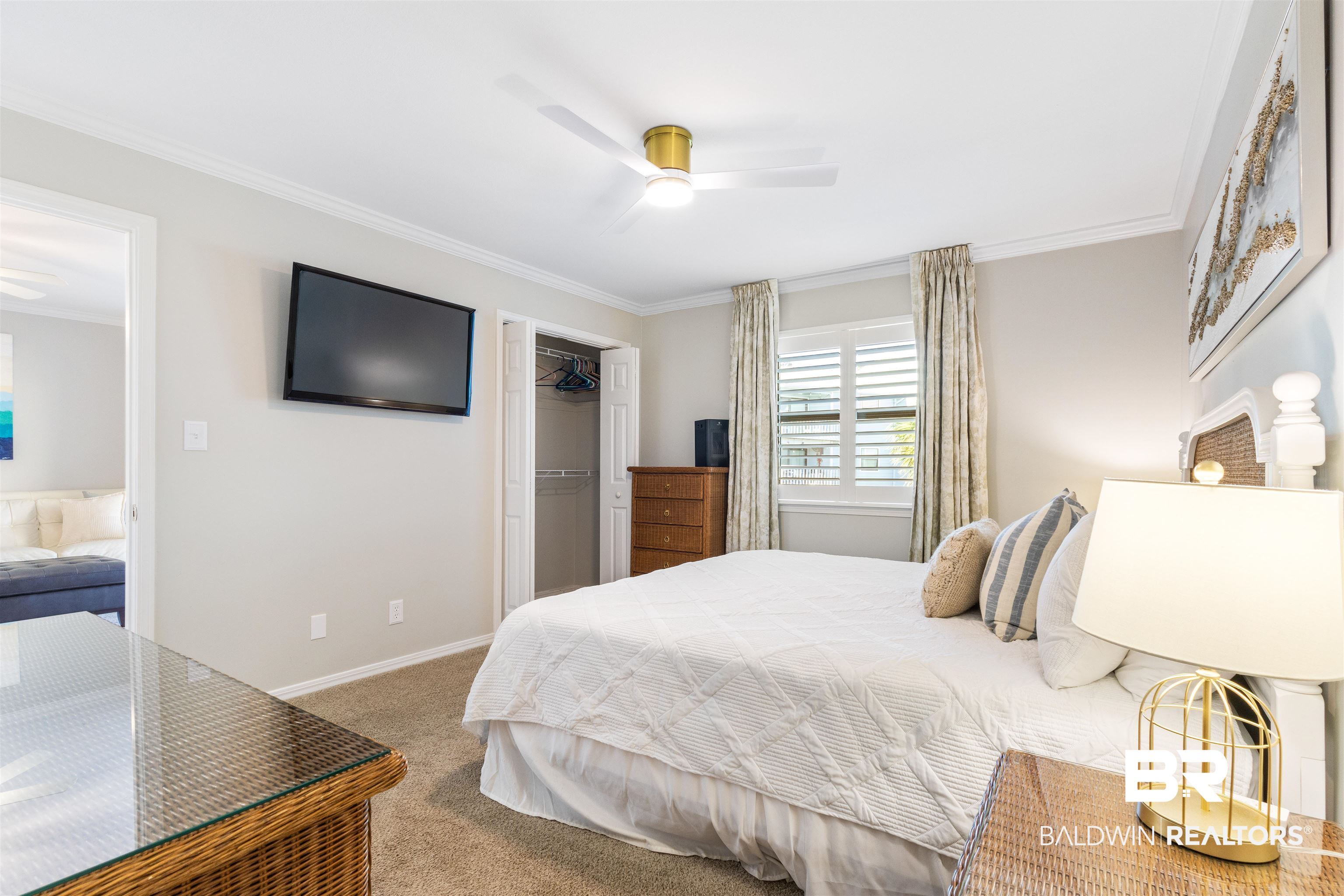 25861 Canal Road, Unit 3 Orange Beach, AL 36561 - Photo 15 of 40 Bedroom with carpet, crown molding, a walk in closet, and a ceiling fan