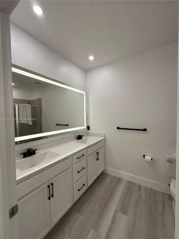 a bathroom with a double vanity sink and mirror