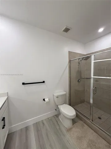 a bathroom with a toilet and a shower
