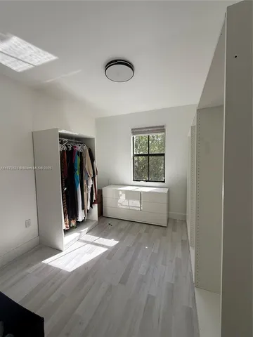 a view of a livingroom with a window and a ceiling fan