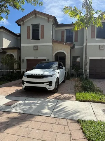 a car parked in front of white house
