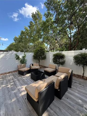 a view of a patio with couches and potted plants
