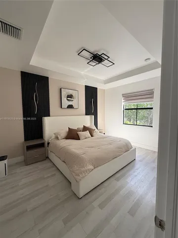 a spacious bedroom with a bed and a window