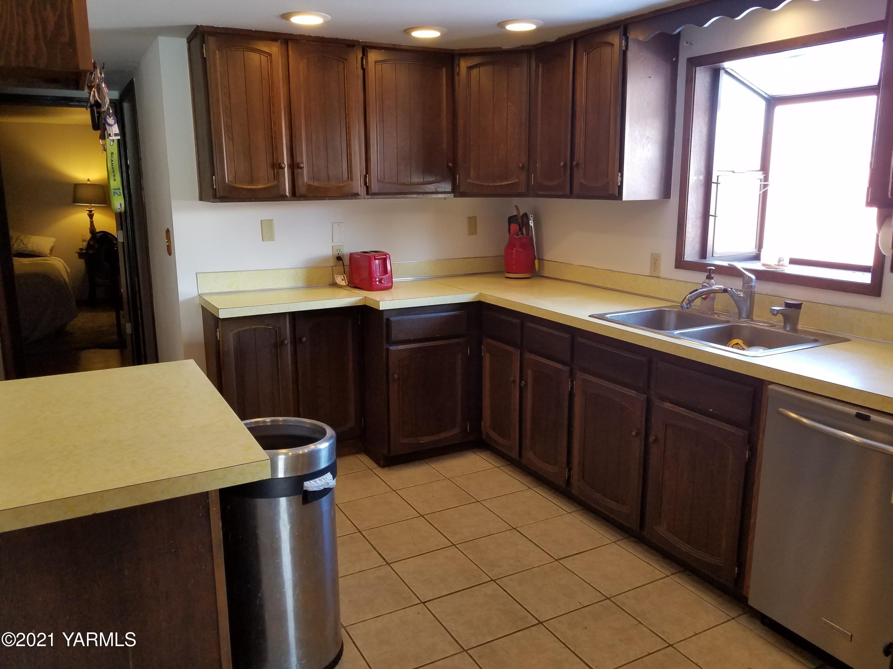 501 Mohar Road Grandview, WA 98930 - Photo 2 of 24 a kitchen with a sink cabinets and a window