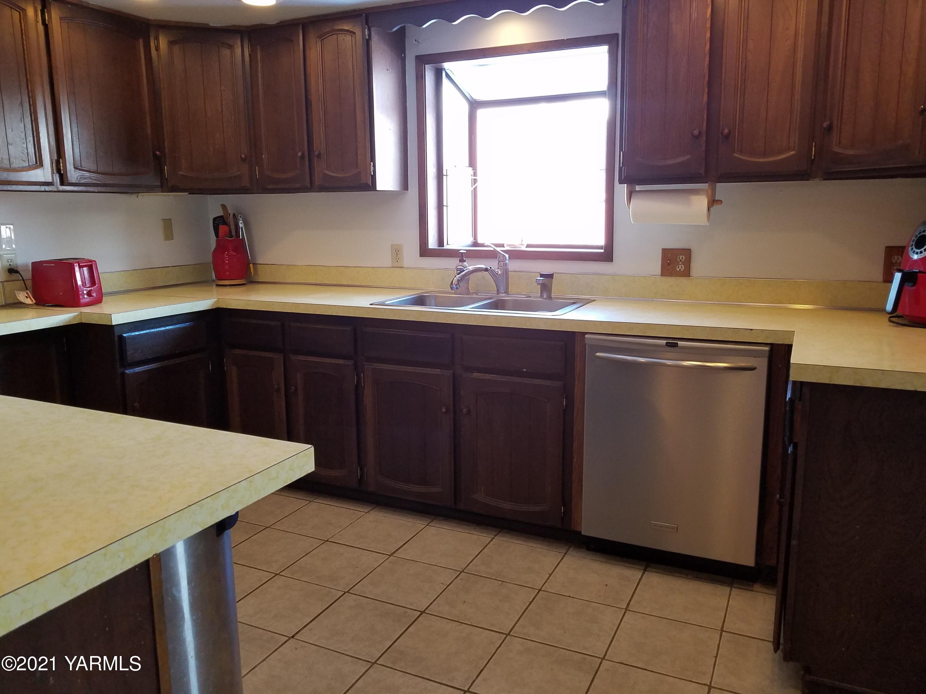501 Mohar Road Grandview, WA 98930 - Photo 3 of 24 a kitchen with a sink cabinets and wooden floor