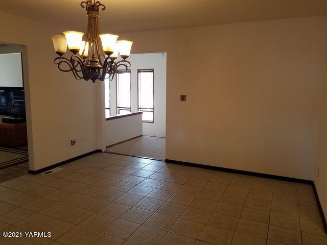 501 Mohar Road Grandview, WA 98930 - Photo 5 of 24 a view of a livingroom with a chandelier fan and windows