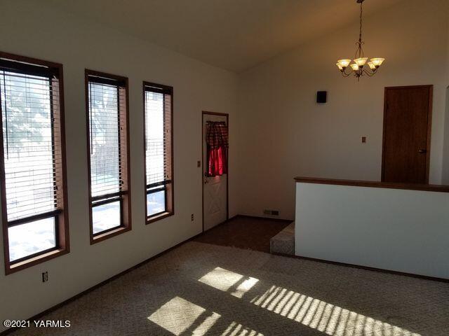 501 Mohar Road Grandview, WA 98930 - Photo 8 of 24 a living room with furniture and a chandelier