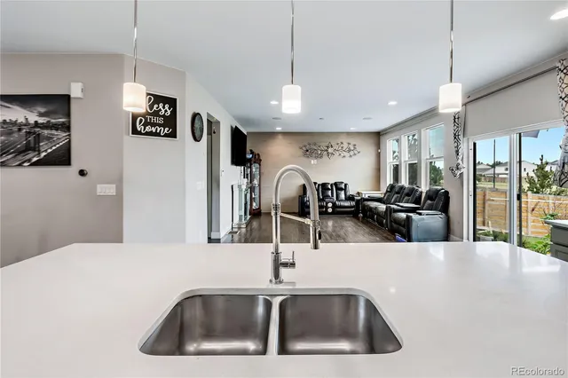 a kitchen with stainless steel appliances a sink and a refrigerator