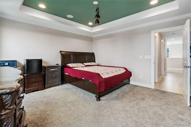 a bedroom with a bed and a flat tv screen on wall