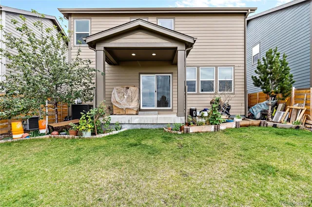 a view of a house with backyard sitting area and garden