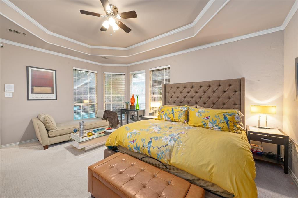 17608 Windflower Way Dallas, TX 75252 - Photo 14 of 34 Carpeted bedroom with a tray ceiling, ornamental molding, and ceiling fan