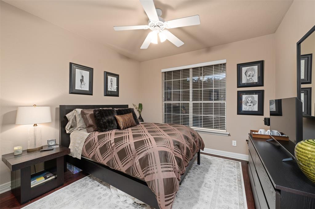 17608 Windflower Way Dallas, TX 75252 - Photo 16 of 34 Bedroom featuring wood finished floors and a ceiling fan