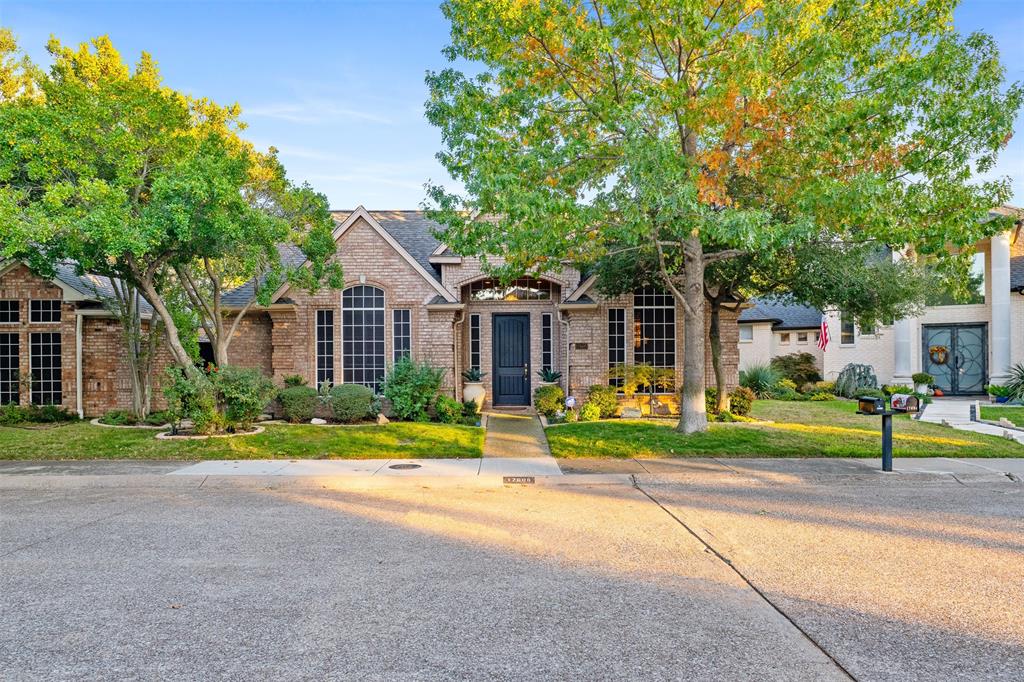 17608 Windflower Way Dallas, TX 75252 - Photo 2 of 34 View of front of house with brick siding, a front yard, and a shingled roof