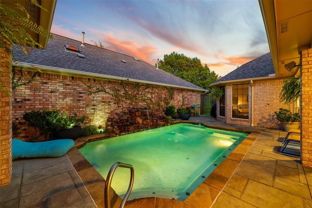 17608 Windflower Way Dallas, TX 75252 - Photo 31 of 34 Pool at dusk featuring a patio