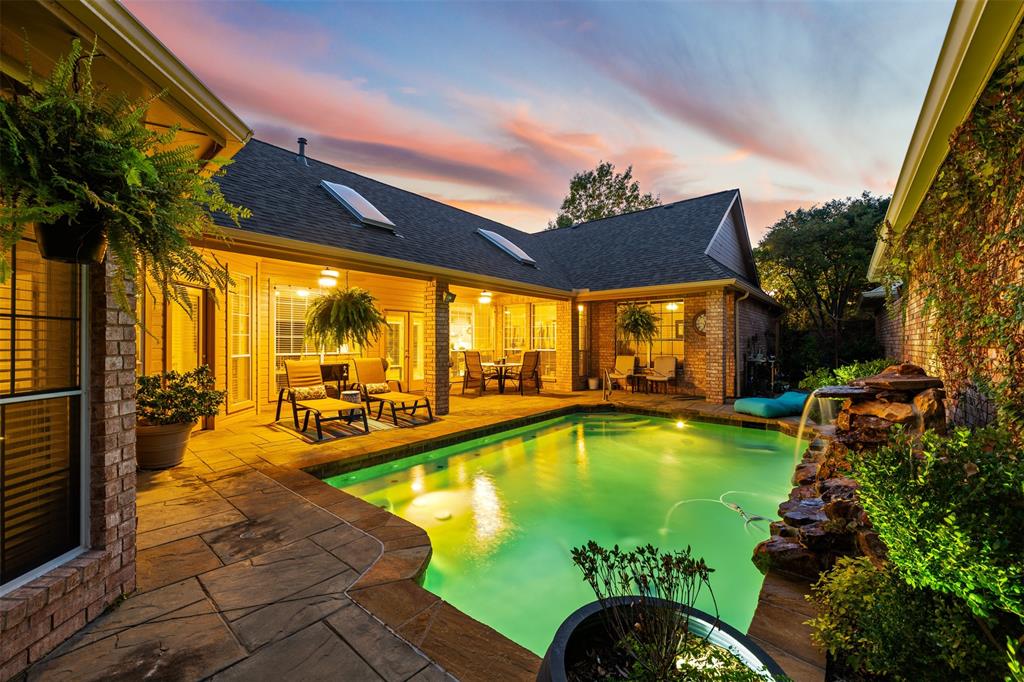 17608 Windflower Way Dallas, TX 75252 - Photo 32 of 34 Pool at dusk with an outdoor pool, a patio area, and outdoor lounge area