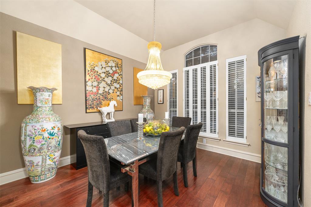 17608 Windflower Way Dallas, TX 75252 - Photo 8 of 34 Dining space featuring dark wood-style floors and lofted ceiling
