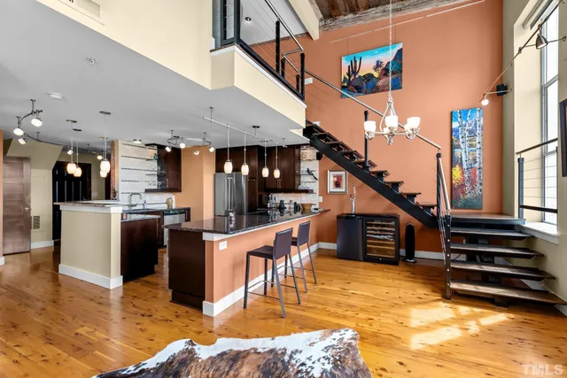 a kitchen with stainless steel appliances kitchen island granite countertop a refrigerator and a stove