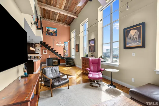a living room with furniture a rug and a window