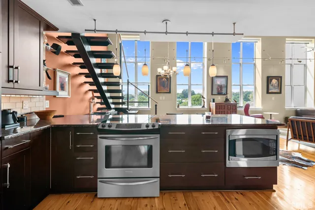 a kitchen with stainless steel appliances granite countertop a stove and a sink