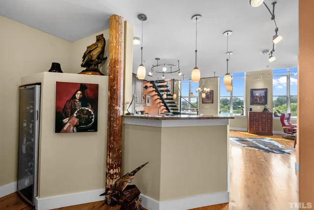 a view of a living room with furniture and a floor to ceiling window