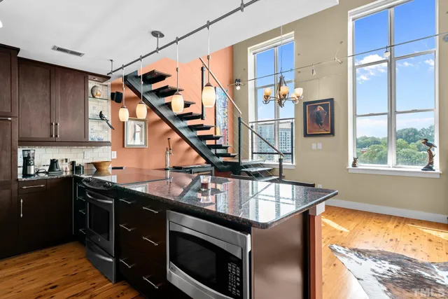 a kitchen with stainless steel appliances granite countertop a stove and a sink
