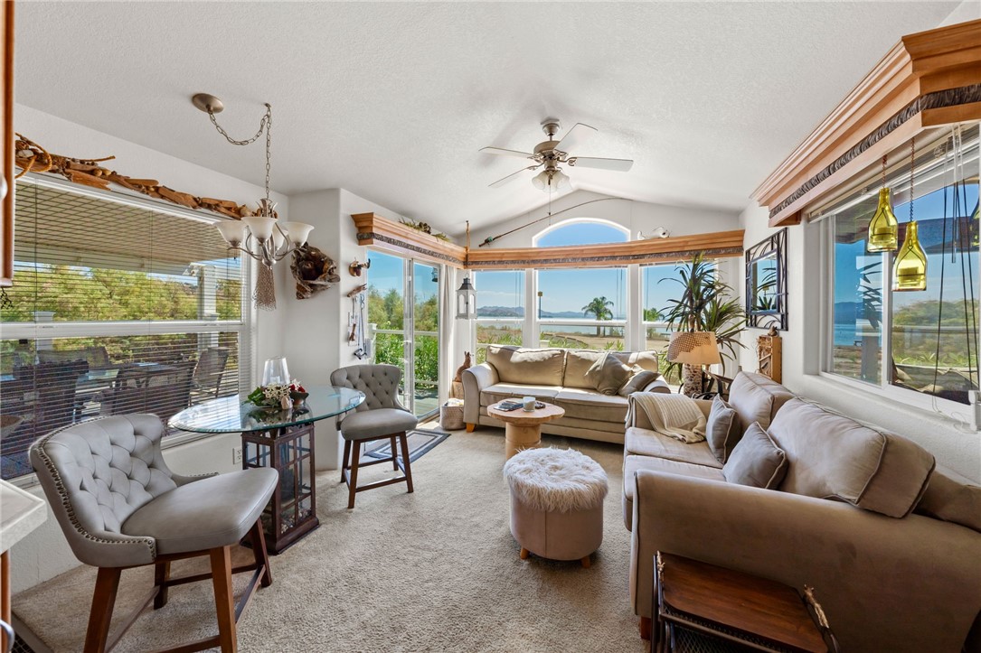 32000 Riverside Drive, Unit J8 Lake Elsinore, CA 92530 - Photo 15 of 33 a living room with furniture a ceiling fan and a large window