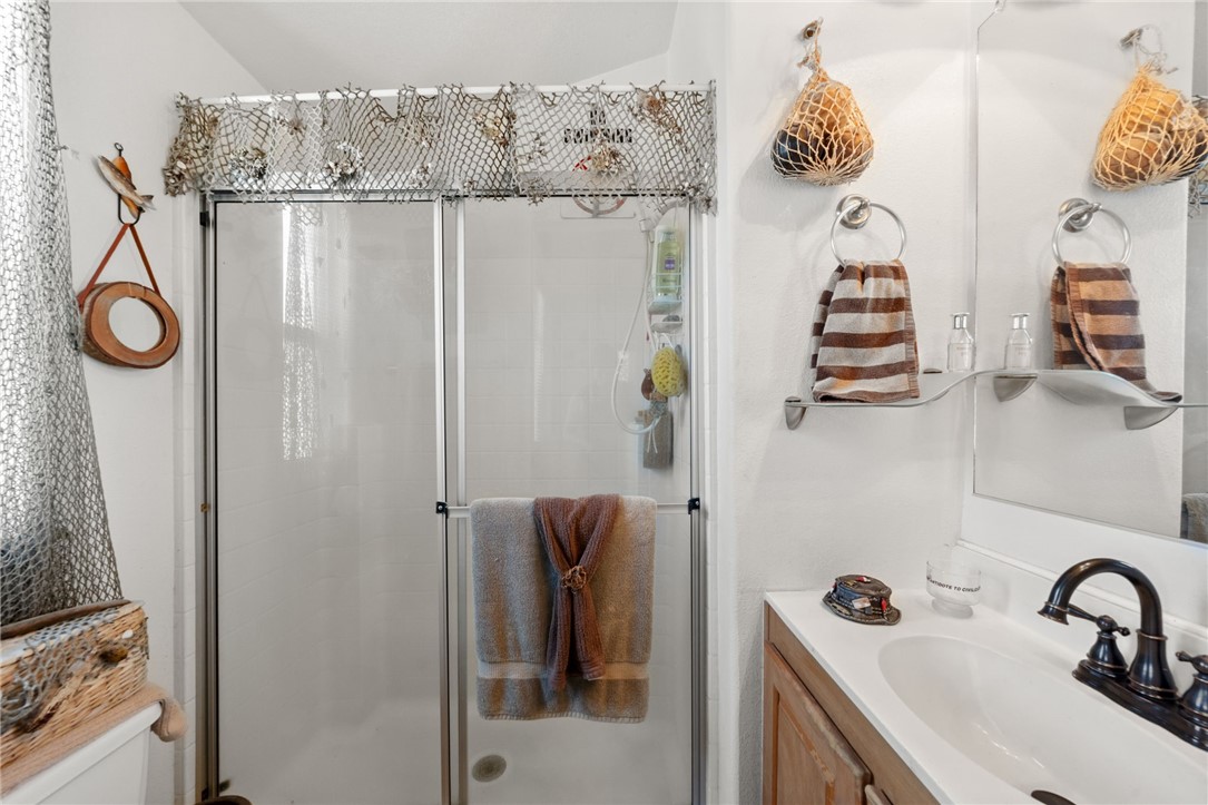 32000 Riverside Drive, Unit J8 Lake Elsinore, CA 92530 - Photo 20 of 33 a bathroom with a sink and mirror