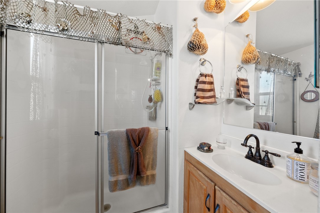 32000 Riverside Drive, Unit J8 Lake Elsinore, CA 92530 - Photo 21 of 33 a bathroom with a sink and mirror