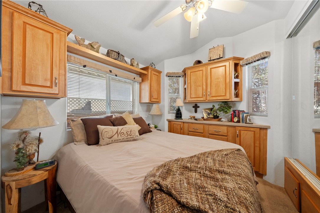 32000 Riverside Drive, Unit J8 Lake Elsinore, CA 92530 - Photo 22 of 33 a bedroom with a large bed and a chandelier