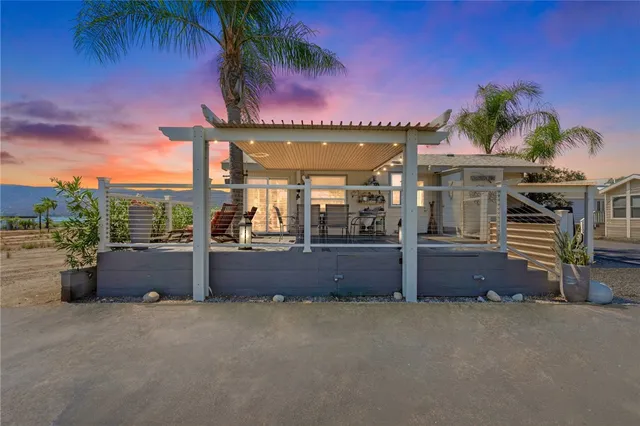 a view of a house with a porch and furniture