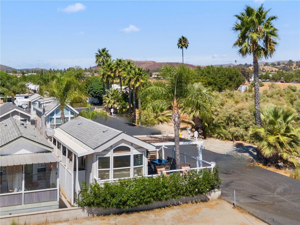 32000 Riverside Drive, Unit J8 Lake Elsinore, CA 92530 - Photo 6 of 33 a front view of a house with a garden