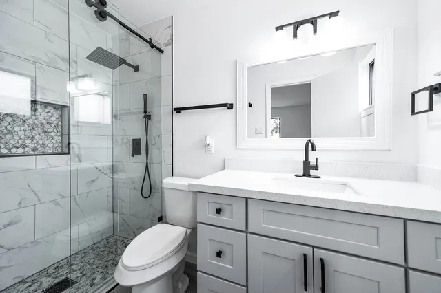 a bathroom with a sink toilet and shower