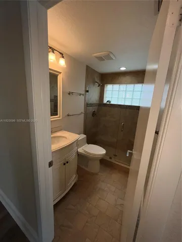 a bathroom with a sink toilet and mirror