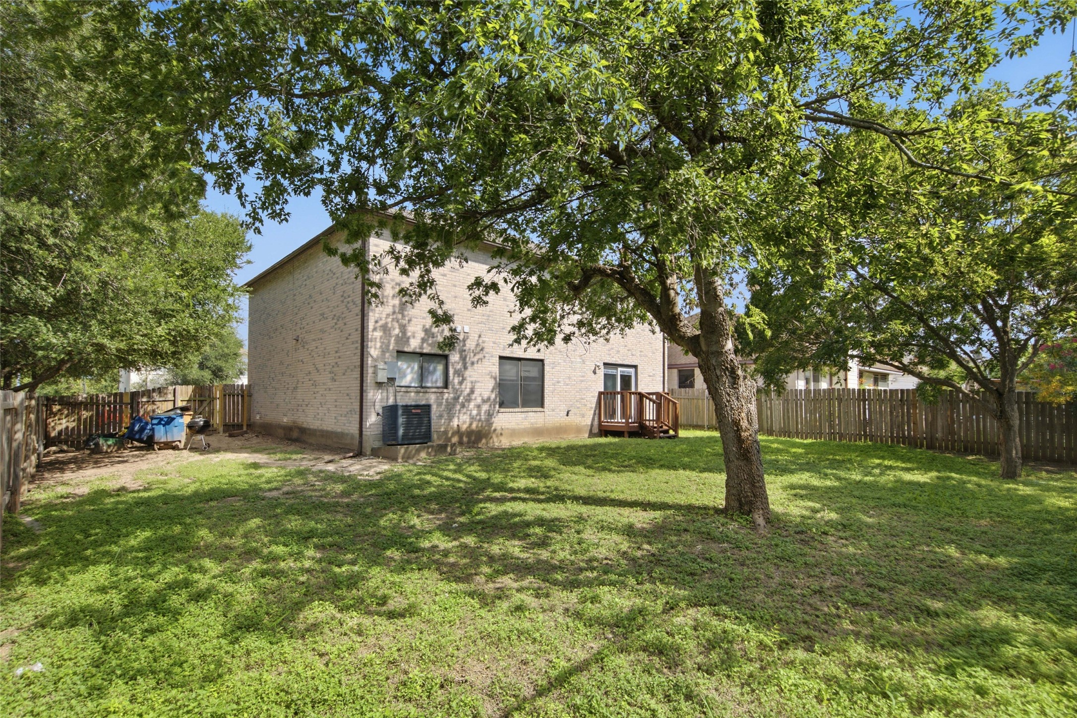 7900 Rosenberry Drive Austin, TX 78747 - Photo 23 of 27 A spacious backyard awaits, complete with a charming deck and mature shade trees.