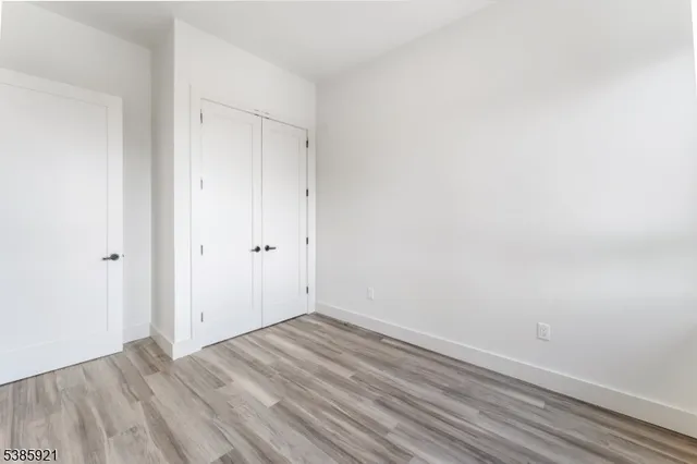 a view of room with wooden floor