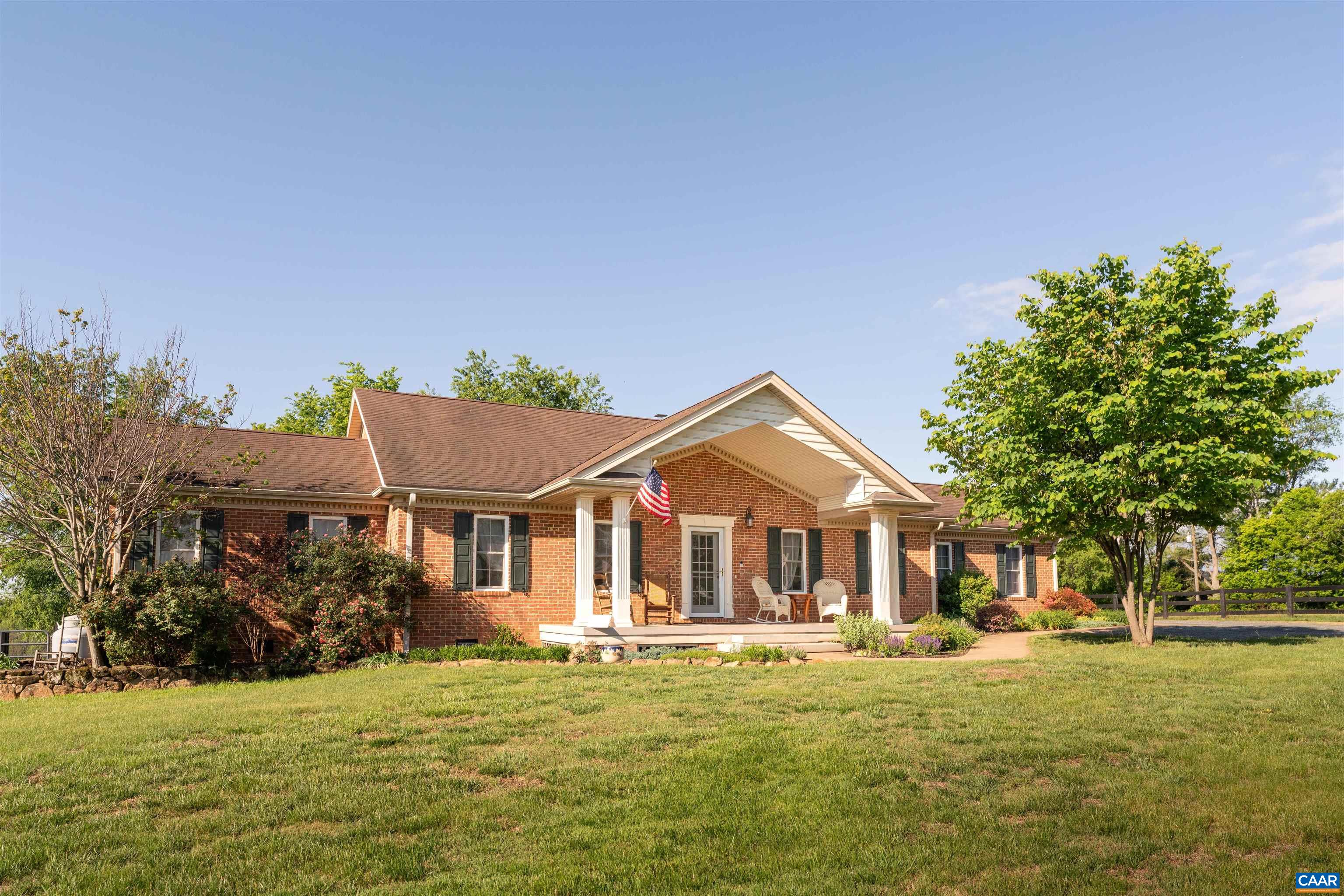 3486 Fredericksburg Road Ruckersville, VA 22968 - Photo 35 of 37 a front view of a house with a garden and trees
