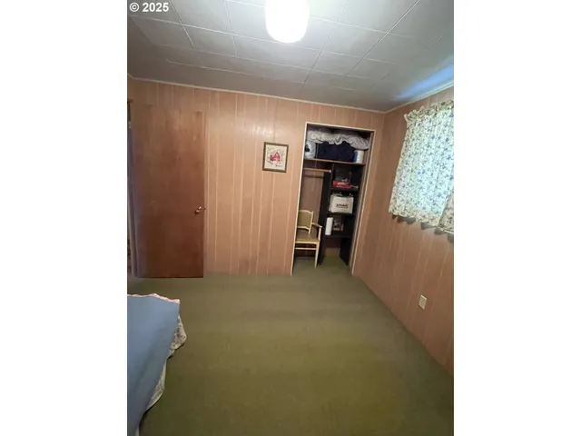 a view of hallway with furniture and a window