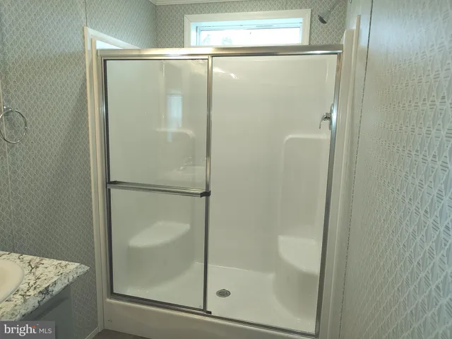 a bathroom with a glass shower door