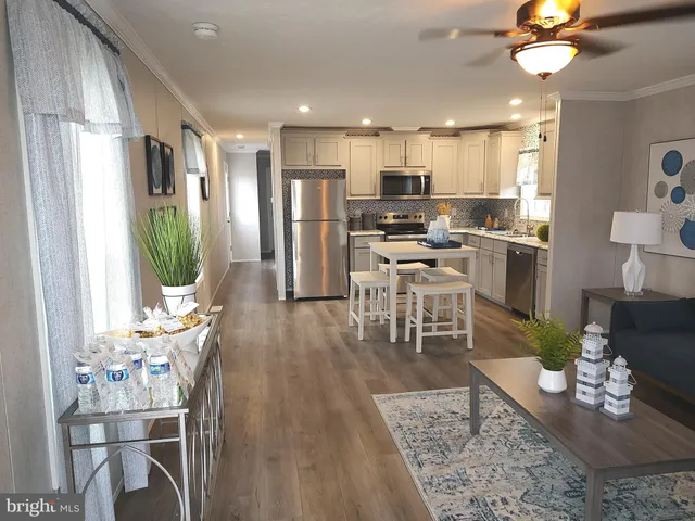 a living room with lots of furniture and kitchen view