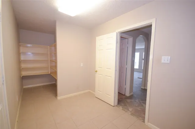 a view of an empty room and closet area