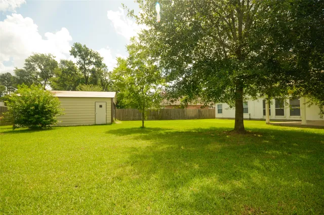 a view of a trees with a house in the background