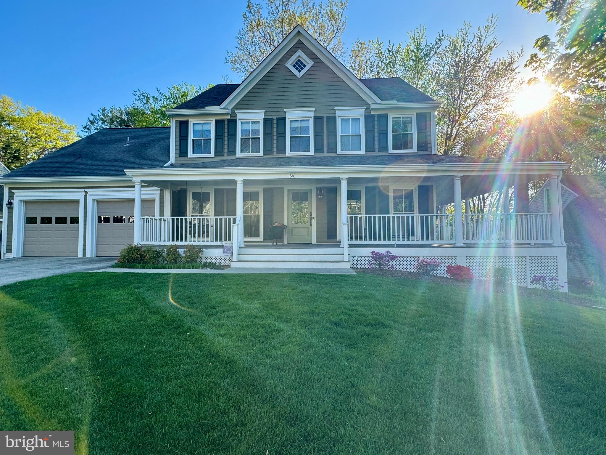 Beautiful exterior with wrap porch and lush lawn!