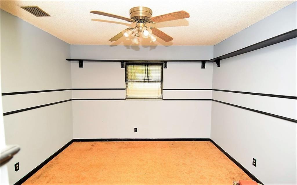 3850 Southeast Middle Street Stuart, FL 34997 - Photo 11 of 11 a view of a room with a ceiling fan and a window