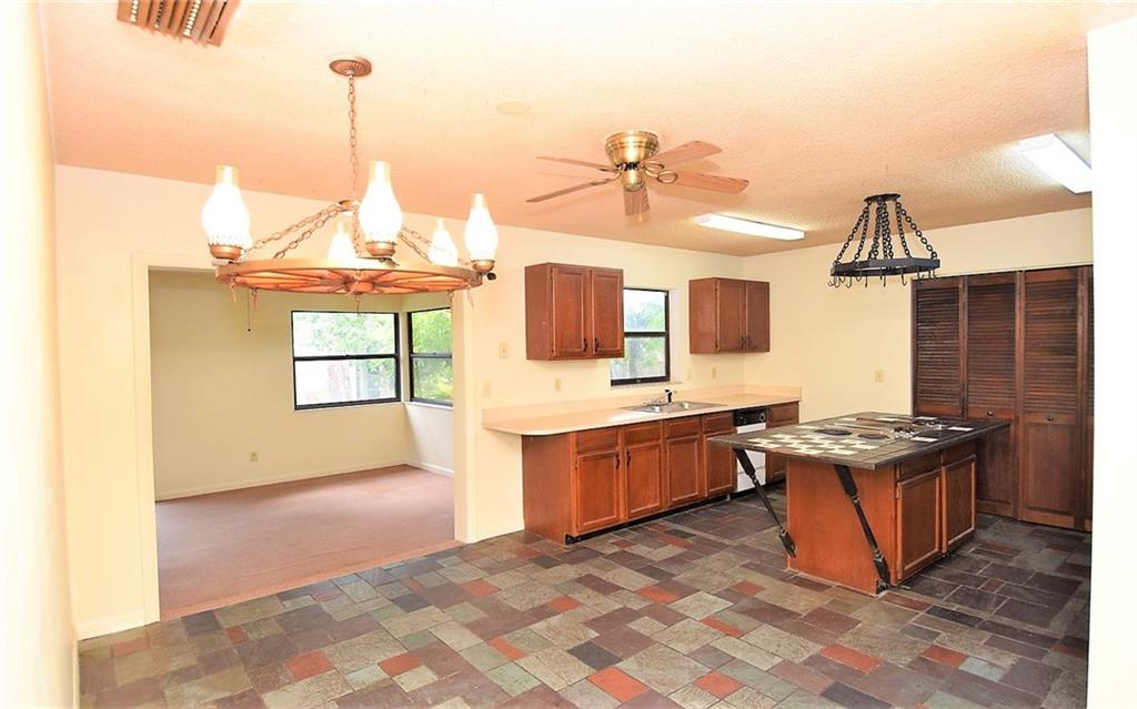 3850 Southeast Middle Street Stuart, FL 34997 - Photo 6 of 11 a kitchen with stainless steel appliances granite countertop a stove a sink and a refrigerator