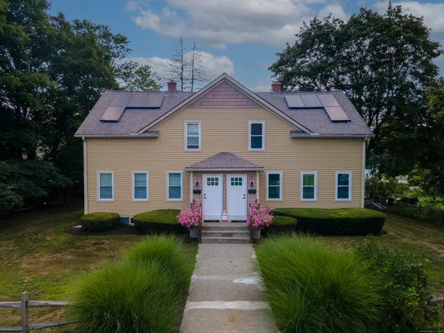 a front view of house with yard and green space