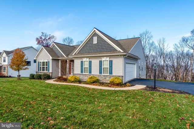 a front view of a house with garden and porch