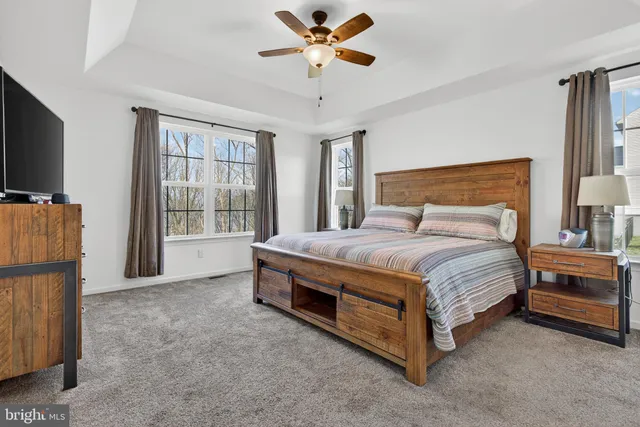 a bedroom with bed and flat screen tv