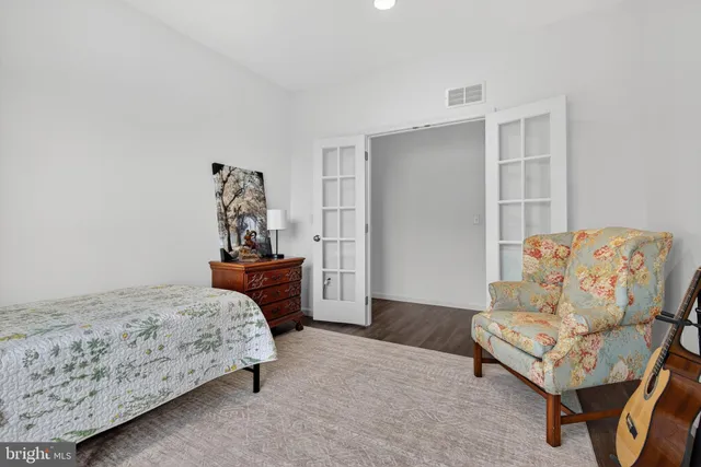 a bed sitting in a room next to a window