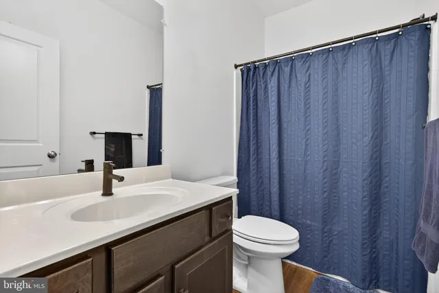 a bedroom with a bed and a flat tv screen on dresser